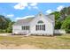 Exterior of beautiful home with white siding, attached garage, and manicured landscaping at 5612 Sandy Trail Dr, Knightdale, NC 27545
