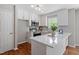 Charming kitchen with white cabinets, stainless steel appliances, and quartz countertops at 5612 Sandy Trail Dr, Knightdale, NC 27545