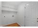 Utility room with white walls, wood floor, shelving, and a white door at 5612 Sandy Trail Dr, Knightdale, NC 27545
