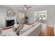 Open concept living room featuring a fireplace, view to kitchen, and hardwood flooring at 5612 Sandy Trail Dr, Knightdale, NC 27545