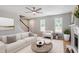 Comfortable living room with a fireplace, ceiling fan, and bright windows at 5612 Sandy Trail Dr, Knightdale, NC 27545
