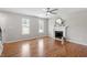 Spacious living room showcasing hardwood floors and a fireplace with windows that provide natural light at 5612 Sandy Trail Dr, Knightdale, NC 27545