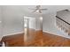 Inviting living room with hardwood floors, ceiling fan, and staircase, offering a bright and airy space at 5612 Sandy Trail Dr, Knightdale, NC 27545