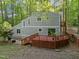 Exterior home view showcasing expansive wooden deck and forest backdrop at 568 Piney Mountain Rd, Chapel Hill, NC 27514