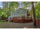 Two story home with deck nestled within a lush green forest landscape at 568 Piney Mountain Rd, Chapel Hill, NC 27514