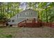 Exterior of home with two story deck, grill, and wood backdrop at 568 Piney Mountain Rd, Chapel Hill, NC 27514