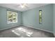 Spacious bedroom with neutral carpet, light-blue walls, and lots of sunlight at 568 Piney Mountain Rd, Chapel Hill, NC 27514