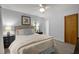 Clean bedroom with neutral carpet, light walls, a ceiling fan, and black nightstands at 568 Piney Mountain Rd, Chapel Hill, NC 27514
