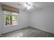 Bright bedroom with a window view, ceiling fan, and neutral color scheme at 568 Piney Mountain Rd, Chapel Hill, NC 27514