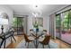Bright dining room with a modern light fixture and access to the outdoor deck at 568 Piney Mountain Rd, Chapel Hill, NC 27514