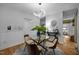 Open dining area with stylish table, pendant lighting, and hardwood floors at 568 Piney Mountain Rd, Chapel Hill, NC 27514