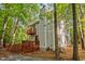 Back exterior view of home with two-story deck and wooded lot at 568 Piney Mountain Rd, Chapel Hill, NC 27514