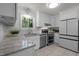 Updated kitchen with granite countertops, stainless steel appliances, and white cabinetry at 568 Piney Mountain Rd, Chapel Hill, NC 27514