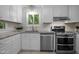 Bright kitchen with granite countertops, white cabinets, and stainless steel appliances at 568 Piney Mountain Rd, Chapel Hill, NC 27514