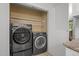 Laundry room with LG washer and dryer units and shelf storage at 568 Piney Mountain Rd, Chapel Hill, NC 27514