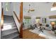 Inviting living room with hardwood floors, high ceilings, lots of natural light, and a staircase at 568 Piney Mountain Rd, Chapel Hill, NC 27514