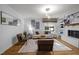Inviting living room with a brick fireplace, built-in shelving, and comfortable seating at 568 Piney Mountain Rd, Chapel Hill, NC 27514