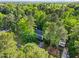 Aerial view of the home and neighborhood, surrounded by mature trees and green spaces at 5701 Hadrian Dr Dr, Durham, NC 27703