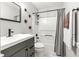 This bathroom features a modern sink with black hardware and a shower-tub combo at 5701 Hadrian Dr Dr, Durham, NC 27703