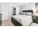 Bedroom features a large bed, overhead lighting, and closet with a washer and dryer at 5701 Hadrian Dr Dr, Durham, NC 27703