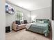 Comfortable bedroom featuring a large bed, a small sofa, natural light and a tv at 5701 Hadrian Dr Dr, Durham, NC 27703