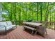 Outdoor deck with a seating area, dining table, and natural views at 5701 Hadrian Dr Dr, Durham, NC 27703