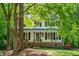 Inviting two-story home with a covered front porch, complete with classic black shutters and beautiful landscaping at 5701 Hadrian Dr Dr, Durham, NC 27703