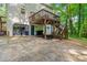 View of the back exterior with a garage, deck, and backyard landscaping at 5701 Hadrian Dr Dr, Durham, NC 27703