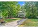 Charming two-story home featuring a welcoming front porch and a well-manicured front yard surrounded by mature trees at 5701 Hadrian Dr Dr, Durham, NC 27703