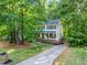Charming two-story home featuring a welcoming front porch and a well-manicured front yard surrounded by mature trees at 5701 Hadrian Dr Dr, Durham, NC 27703