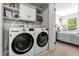 Convenient laundry room with modern appliances and ample storage space, leading to the main bedroom at 5701 Hadrian Dr Dr, Durham, NC 27703