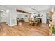 Open-concept living and dining area with hardwood floors, fireplace, and wood beam feature at 5701 Hadrian Dr Dr, Durham, NC 27703