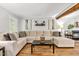 Bright living room with hardwood floors, a large sectional sofa, and decorative touches at 5701 Hadrian Dr Dr, Durham, NC 27703