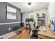 Bright office space featuring hardwood floors, gray accent wall, two work stations, and natural light at 5701 Hadrian Dr Dr, Durham, NC 27703