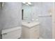 Bright bathroom showcasing a vanity, toilet, and large mirror at 5825 Scalybark Rd, Durham, NC 27712