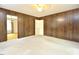 Large bedroom with wood paneled walls, a ceiling fan and an adjoining room at 5825 Scalybark Rd, Durham, NC 27712