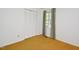 Minimalist bedroom with light-colored walls, carpet flooring, a window with curtains, and a closet at 5825 Scalybark Rd, Durham, NC 27712