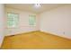 Spacious bedroom featuring two windows and a neutral color palette at 5825 Scalybark Rd, Durham, NC 27712