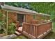 Exterior wooden deck, perfect for outdoor relaxation, offering a secluded spot amidst lush greenery at 5825 Scalybark Rd, Durham, NC 27712