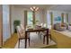 Staged dining room features a decorative light fixture and seating for six guests at 5825 Scalybark Rd, Durham, NC 27712