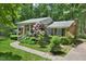 Quaint brick home with a well-maintained lawn and landscaping at 5825 Scalybark Rd, Durham, NC 27712