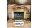 Charming brick fireplace with gas logs, a cozy centerpiece for the living area at 5825 Scalybark Rd, Durham, NC 27712
