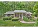 Charming brick home featuring a well-maintained lawn, mature trees, and a welcoming front porch at 5825 Scalybark Rd, Durham, NC 27712