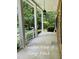Inviting front porch with columns, showcasing a relaxing outdoor space with views of the front yard at 5825 Scalybark Rd, Durham, NC 27712