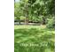 Expansive front yard featuring lush greenery, providing ample space for outdoor activities at 5825 Scalybark Rd, Durham, NC 27712