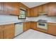 Traditional kitchen design with classic wood cabinetry and white countertops at 5825 Scalybark Rd, Durham, NC 27712