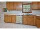 Traditional kitchen with wood cabinets, neutral countertops, and a window overlooking the landscape at 5825 Scalybark Rd, Durham, NC 27712