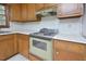 Kitchen featuring wood cabinets, white countertops, and vintage appliances at 5825 Scalybark Rd, Durham, NC 27712
