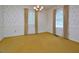 Spacious living room features bright windows and classic wallpaper accents at 5825 Scalybark Rd, Durham, NC 27712