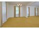 Bright living room with large windows and an elegant chandelier at 5825 Scalybark Rd, Durham, NC 27712
